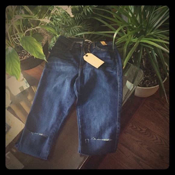 Distressed dark denim jeans