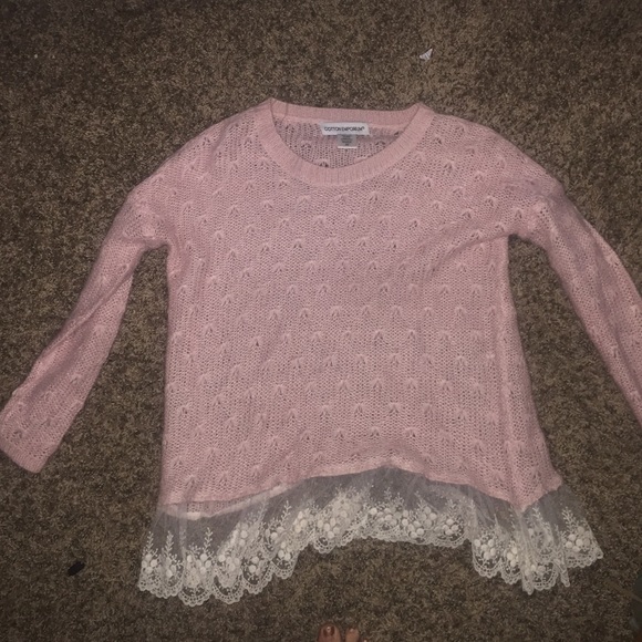 Baby pink sweater with lace trim at the bottom