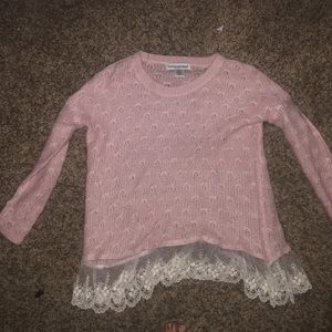 Baby pink sweater with lace trim at the bottom