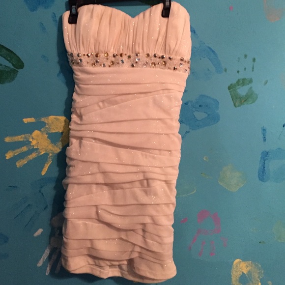 White sparkly homecoming dress with jewels.
