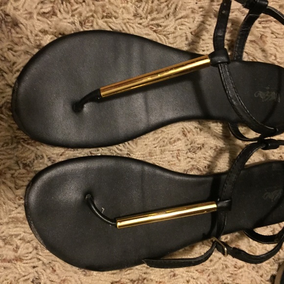 black sandals with gold bar