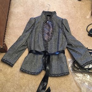 Andrew GN. Skirt suit with 2 belts.