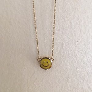 A happy face necklaces with the tag on!