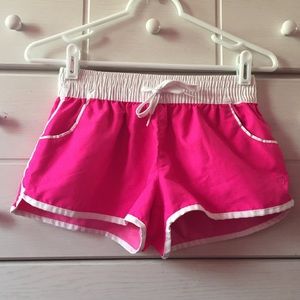Pink and white swim/surf shorts