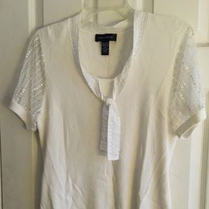 Top with sequined sleeves and neckline.