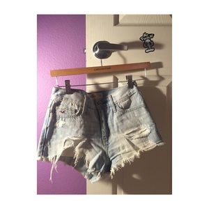 Light wash jean shorts with designed rips