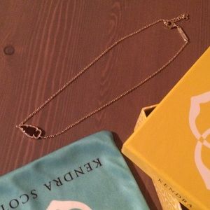 Rare burgundy iridescent stone necklace in gold.