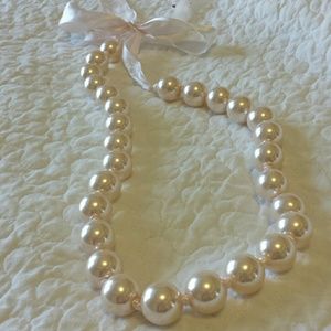 Large faux pearls on a pale pink ribbon