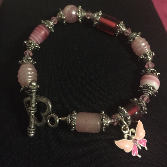 Pink bracelet with butterfly charm and heart clasp