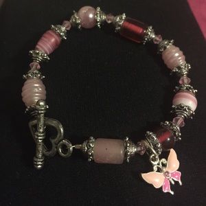 Pink bracelet with butterfly charm and heart clasp