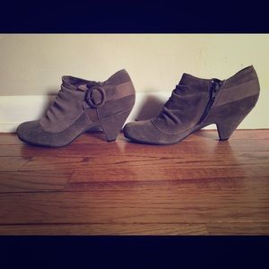 Brown suede booties with decorative detail.
