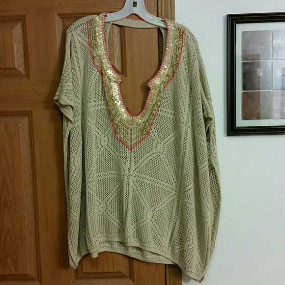 V-neck tan sweater with gold accents