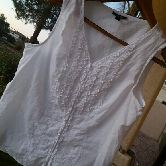 White sleeveless button down with ruffled front