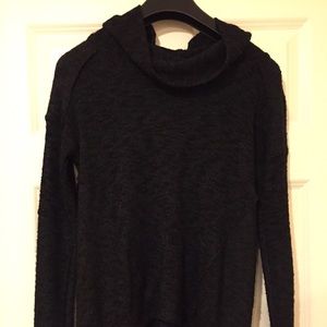 A long sleeve sweater with a loose turtle neck