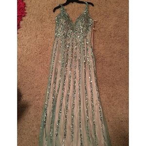 A long, turquoise elegant prom or homecoming dress