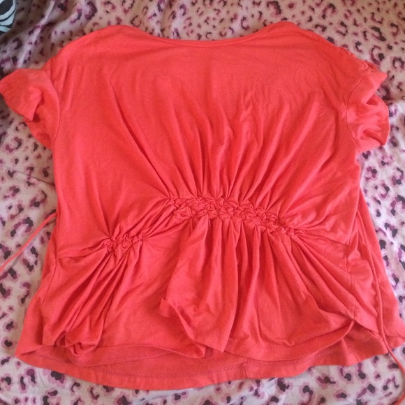 Flowing pink shirt.