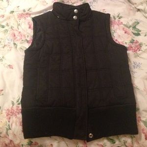 Black button up or zip up vest