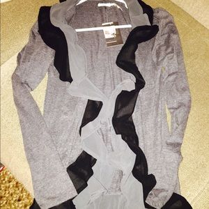 KimChi Blue cardigan sweater with ruffle detail.