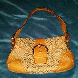Brown Coach Handbag with Buckle Closure