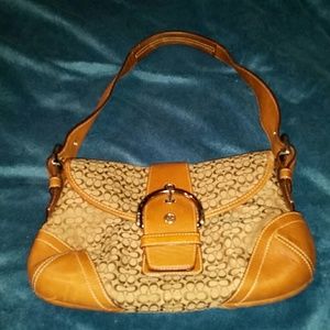 Brown Coach Handbag with Buckle Closure