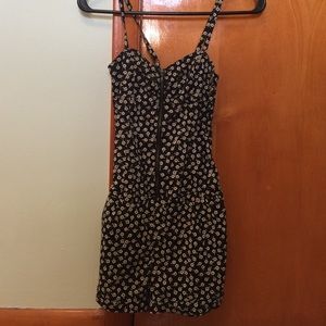 Black romper with white and yellow flowers