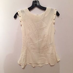 Cream tank with gold stud details.