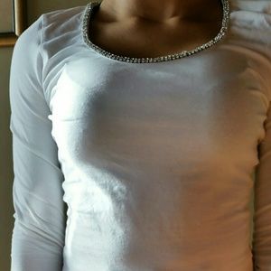 A white long sleeve tee with detailing