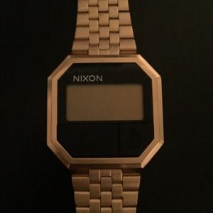 Nixon gold and black watch for men or women