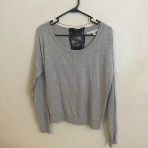 A grey sweater with lace