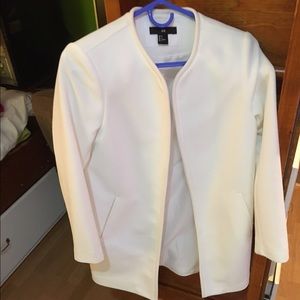White thigh-length blazer.