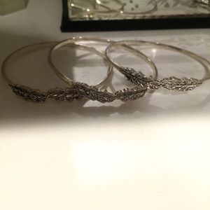 Silver bangles with feather accent
