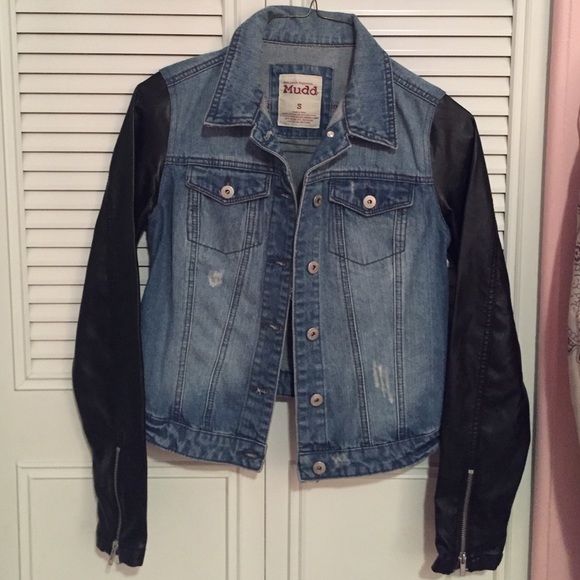 Jean jacket with leather sleeves.