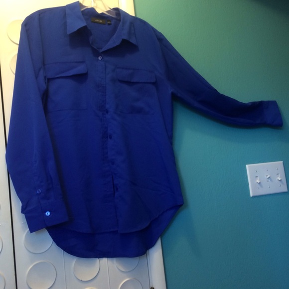 Royal blue blouse with shirttail hem.