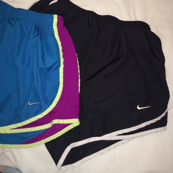 Two pairs of Nike shorts. One black and one blue