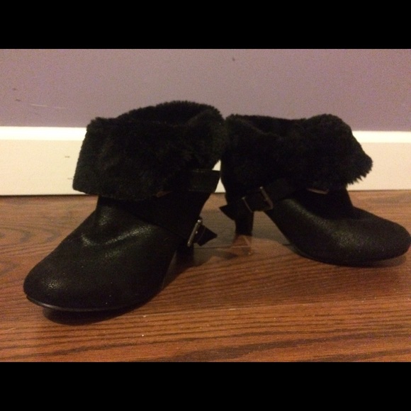 A pair of black heeled ankle shoes