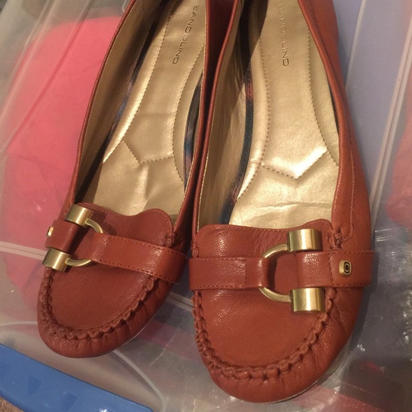 Brown loafer with gold buckle.