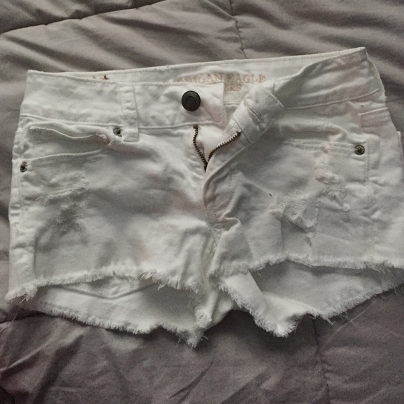 White ripped American eagle shorts