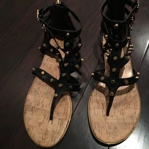 Gold studs and black leather sandals