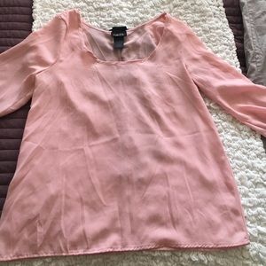 Light pink adorable blouse with black bow on back.