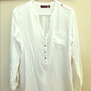 White blouse. Gold buttons.