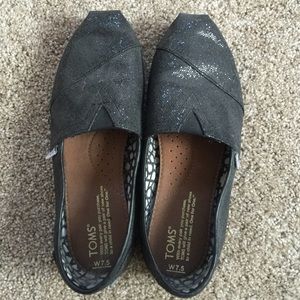 Sparkly black TOMS slip ons