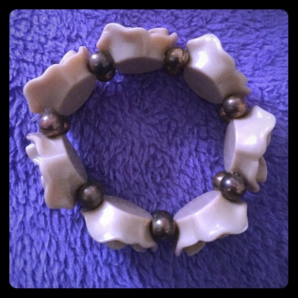 Tan Flower bracelet. With gold beads