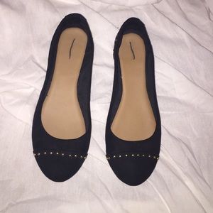 A pair of black flats with gold studs size 10