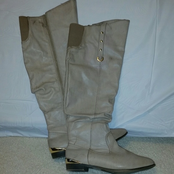 Beige distressed knee boots with gold hardware