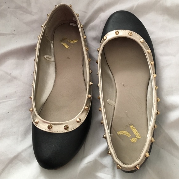 Black and gold trimmed flats with studs