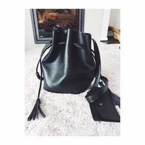 Black leather bucket bag with tassels