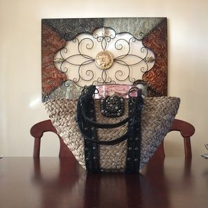 Straw purse with leather straps.