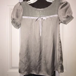 A silver shirt with a lace top.