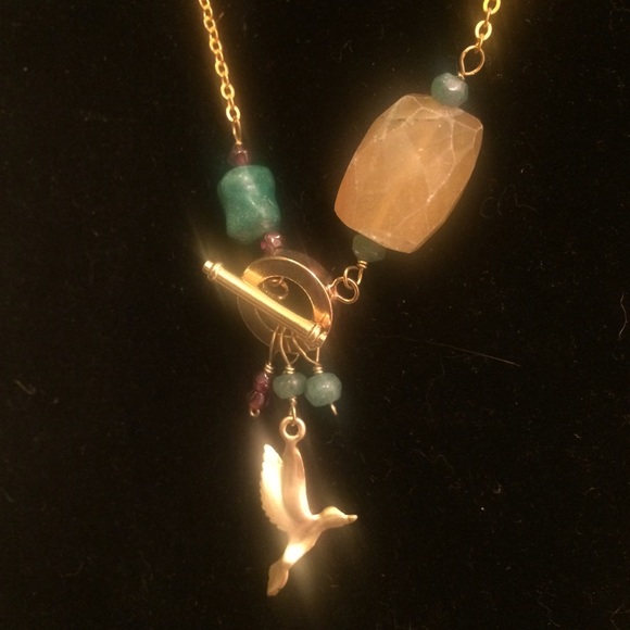 Gold necklace w/ turquoise bird in flight charm