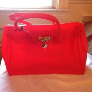 Red rubber purse with lock and key closure